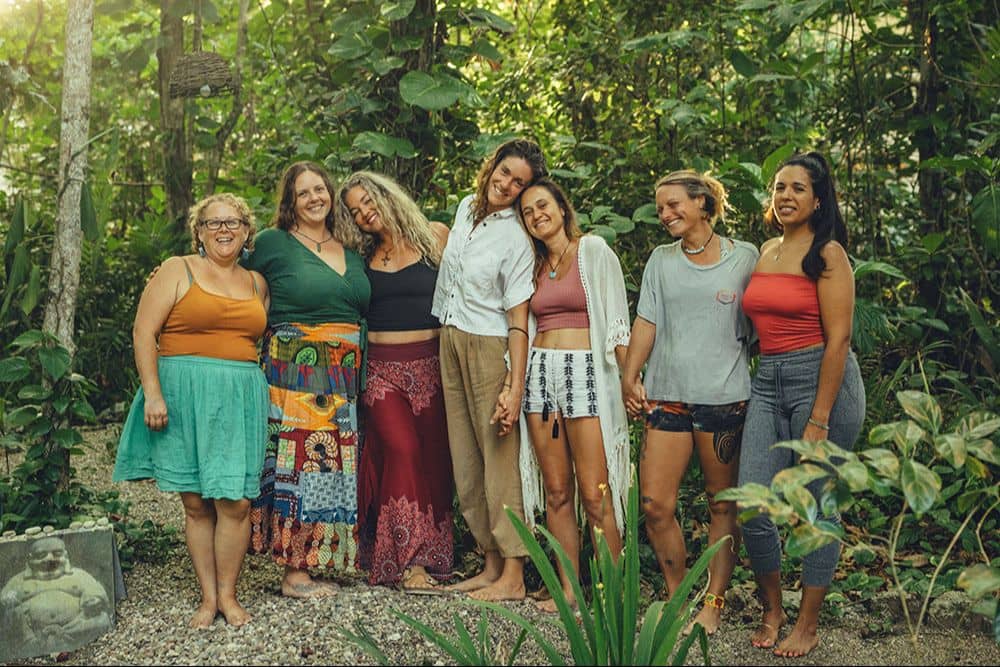 Harriet walking with a group through a garden